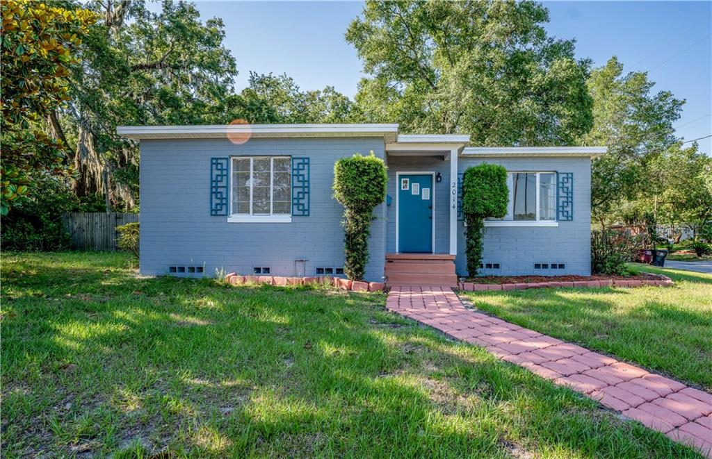 A single-story gray house with a blue front door and a brick walkway — 2014 NEWMAN STREET, ORLANDO, FL