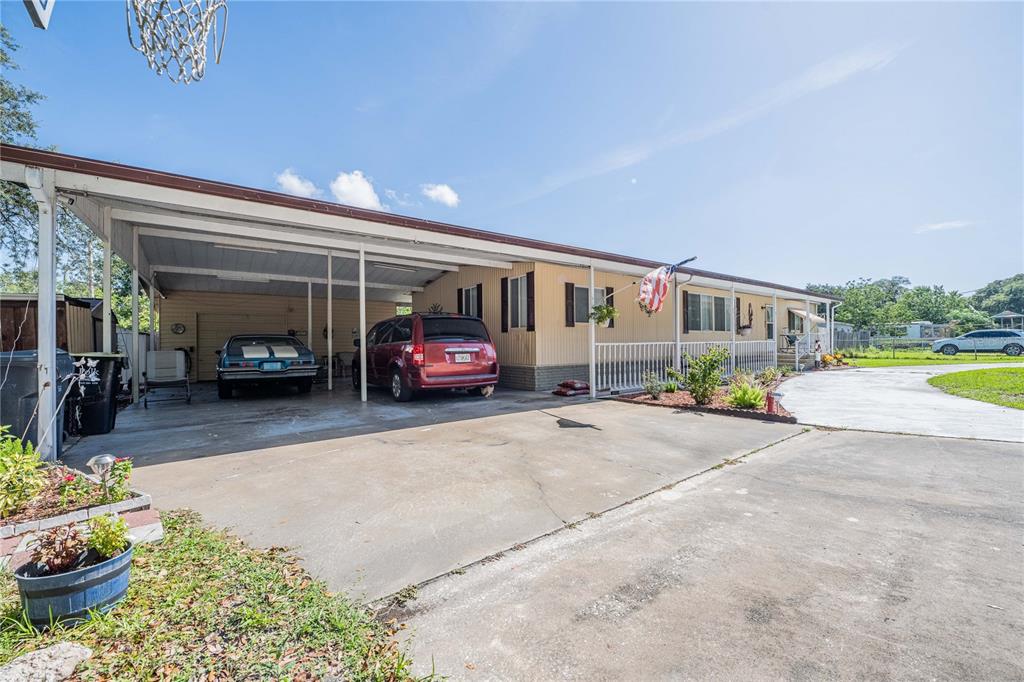 A single-story house with a carport, a concrete driveway, and a front porch — 3140 4TH STREET, DAVENPORT, FL