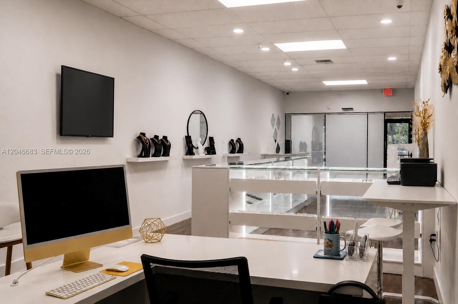 A bright, modern retail jewelry store features white walls, display cases, and a desk area — 1341 N PALM AVE, Miramar FL 33024, MIRAMAR, FL