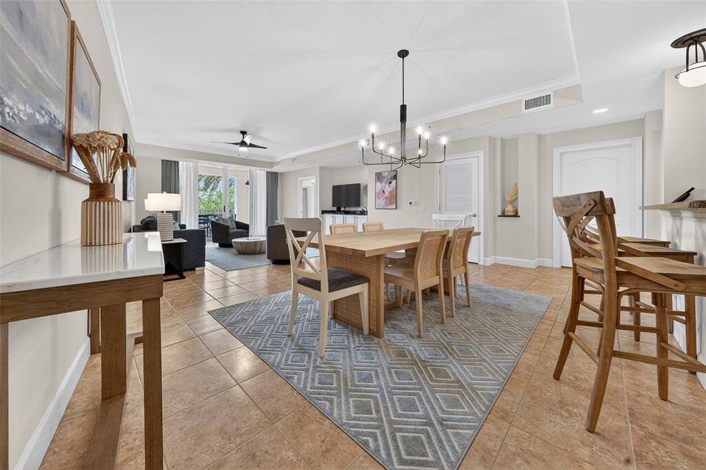 A dining area with a wooden table and chairs sits on a patterned area rug — 102 YACHT HARBOR DRIVE UNIT 365, PALM COAST, FL