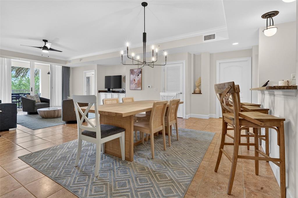 A dining area with a wooden table and chairs sits on a patterned rug — 102 YACHT HARBOR DRIVE UNIT 365, PALM COAST, FL