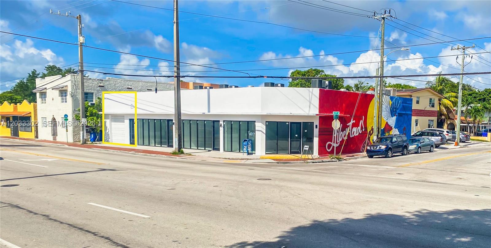 A corner commercial building features a white facade, glass storefront windows, and a large mural — 300 SW 17th Ave # 4, Miami FL 33135, MIAMI, FL