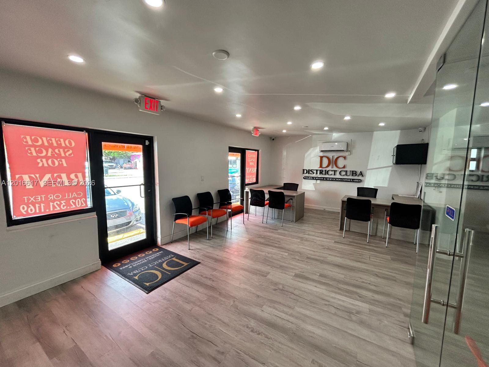 An office interior features light wood flooring, a reception area, and chairs for waiting — 221 E 9th St, Hialeah FL 33010, HIALEAH, FL