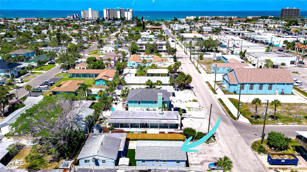 An aerial view shows a blue house with a gray roof and a nearby dumpster — 190 73RD AVENUE UNIT B, ST PETE BEACH, FL