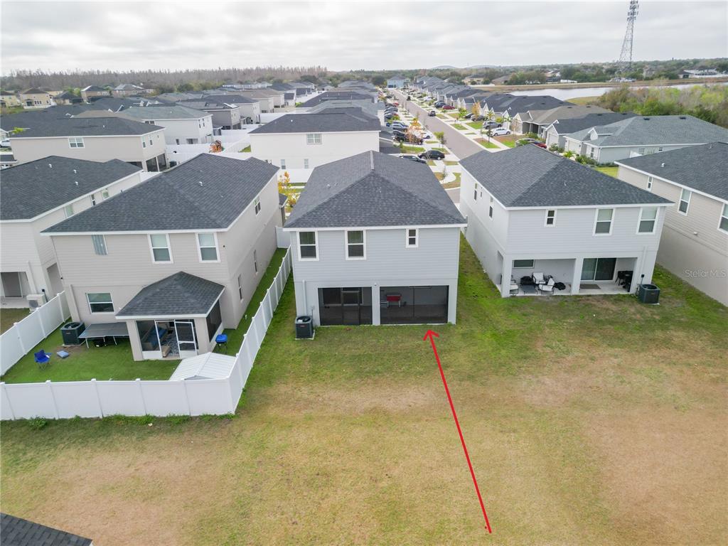 An aerial view shows the rear exterior of a two-story house with a screened patio — 12288 CYPRESS BRANCH STREET, RIVERVIEW, FL