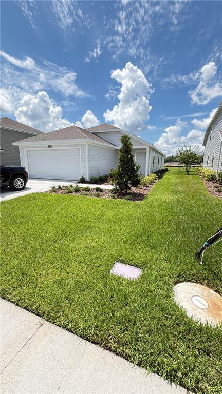 A light gray house exterior features a concrete walkway leading to the front entrance — 5626 MORANT BAY PATH, KISSIMMEE, FL