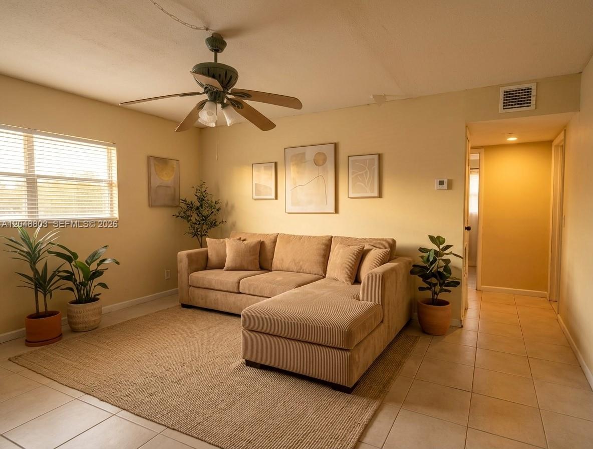 A living room features a beige sectional sofa, a ceiling fan, and potted plants — 1829 N A St # 50, Lake Worth FL 33460, LAKE WORTH, FL