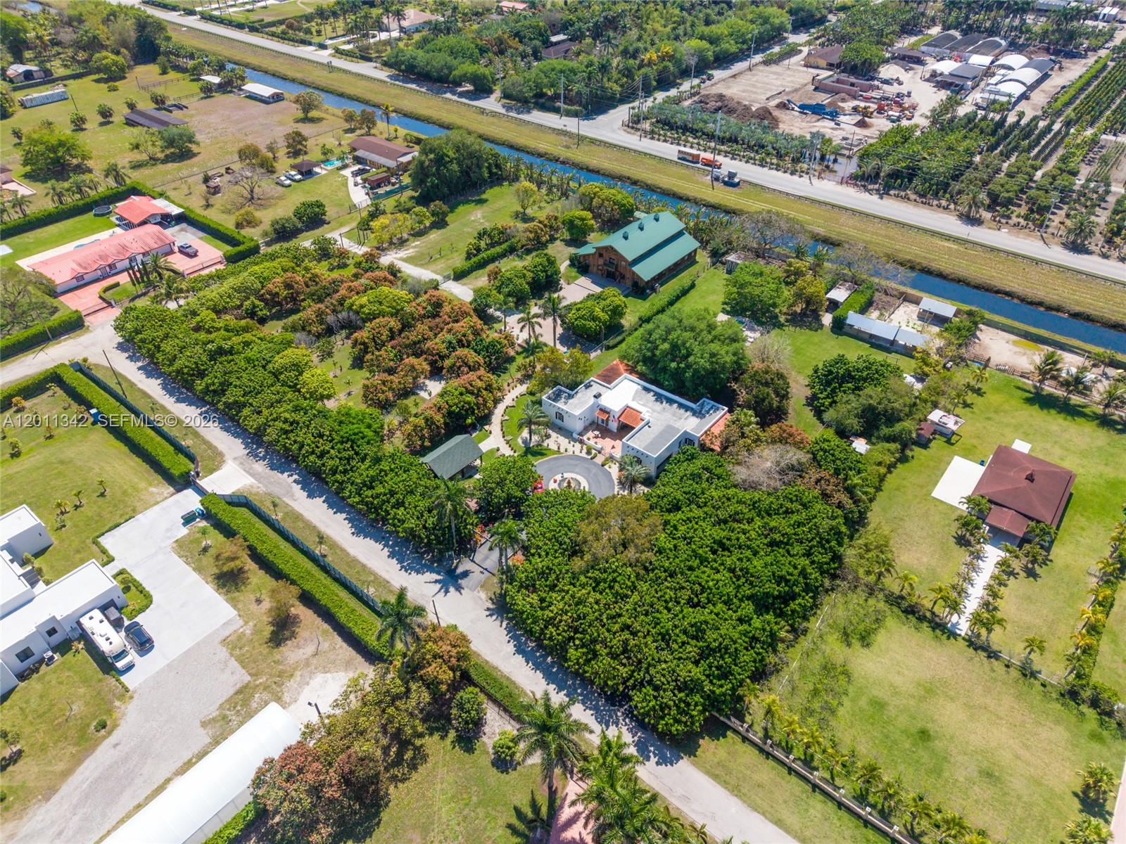 An aerial view shows a large residential property with a circular driveway and lush landscaping — 19050 SW 194th Ave, Miami FL 33187, MIAMI, FL