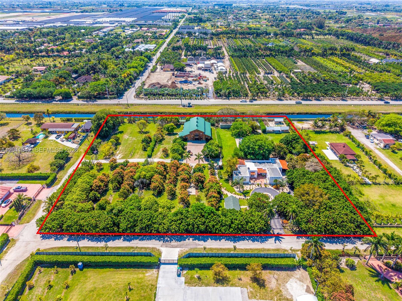 An aerial view shows a large residential property with two houses and extensive landscaped grounds — 19050 SW 194th Ave, Miami FL 33187, MIAMI, FL