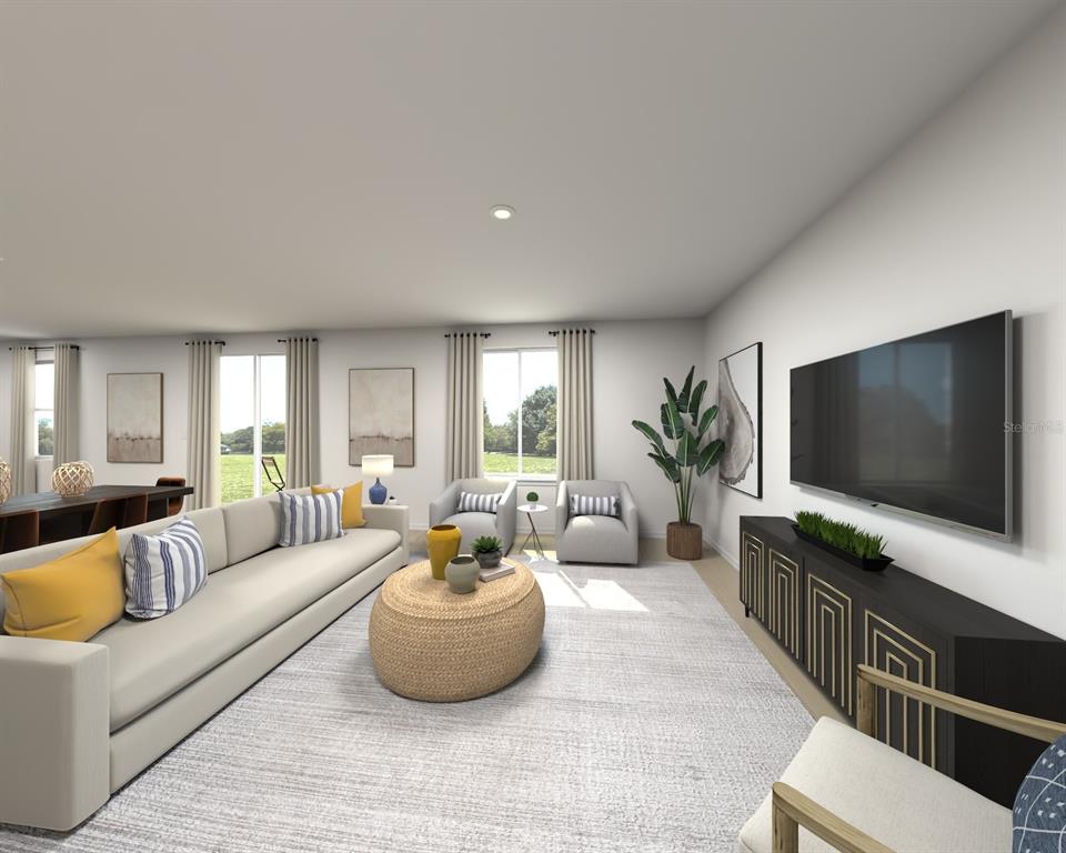 This is a digital rendering of a modern living room with a large sofa and television — 5194 GREEN BELT DRIVE, HAINES CITY, FL