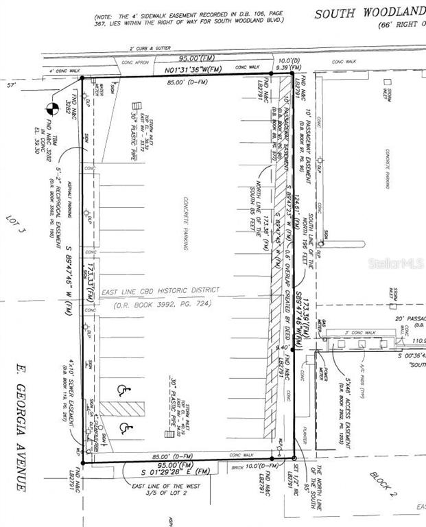 This is a land survey map showing property boundaries, easements, and parking lot dimensions — 113 S WOODLAND BOULEVARD, DELAND, FL