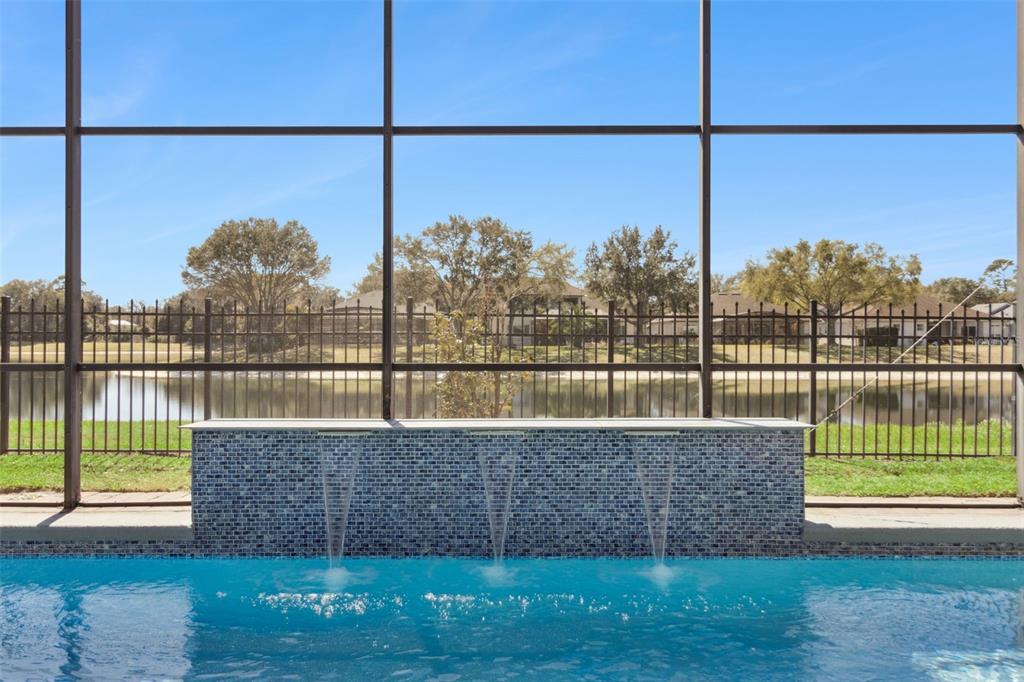 A two-story house with a stone facade, tile roof, and a paved driveway — 6473 EVERINGHAM LANE, SANFORD, FL