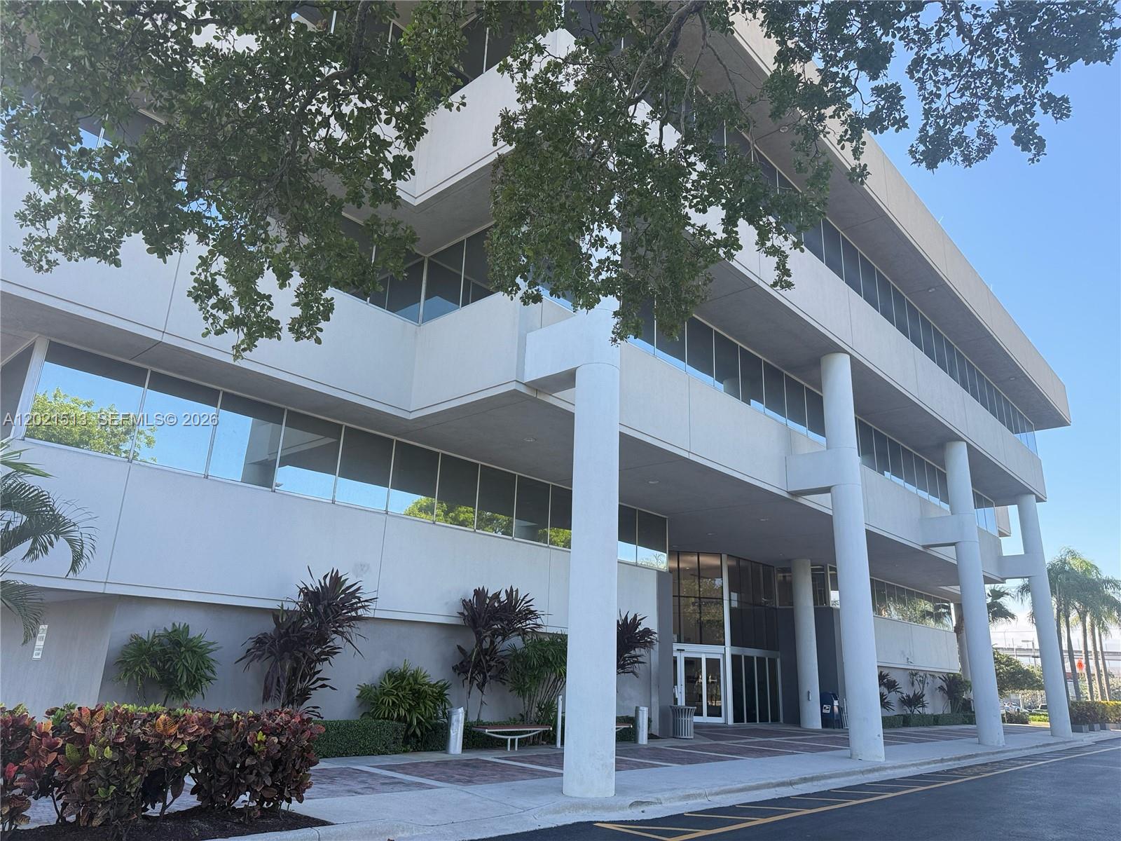 A multi-story office building features a recessed entrance supported by large white cylindrical columns — 290 NW 165th St # 5A, Miami FL 33169, MIAMI, FL