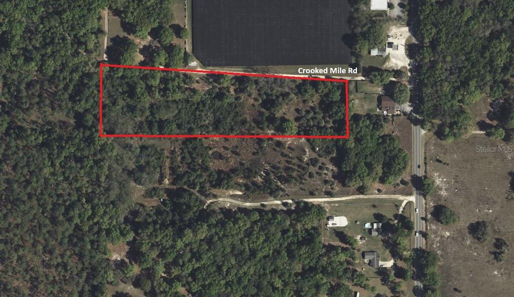 An aerial view shows a rectangular plot of land outlined in red near a road — 0 Crooked Mile ROAD, PAISLEY, FL