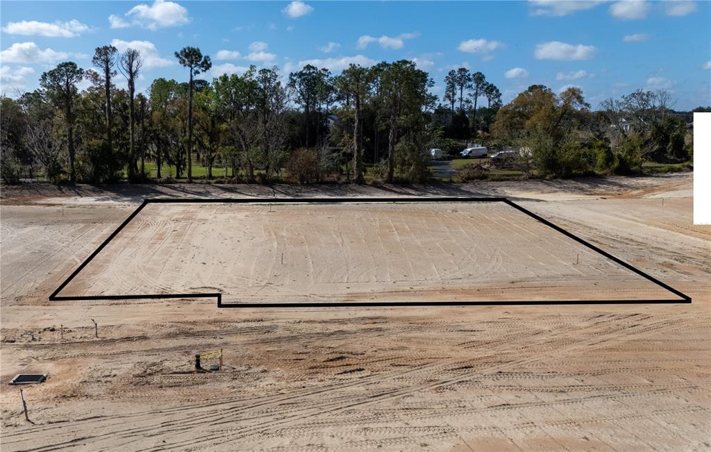 An aerial view shows a cleared, rectangular residential building lot outlined in black — 12891 POMPANIC STREET, SAN ANTONIO, FL