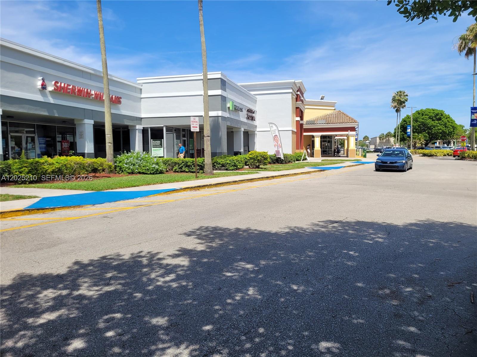 A view of a commercial strip mall with a Sherwin-Williams store and parking lot — 6935 Taft, Hollywood FL 33125, HOLLYWOOD, FL
