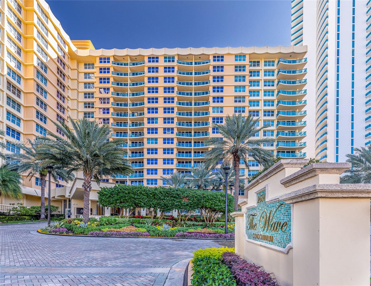 The exterior of a yellow high-rise condominium building features balconies and a landscaped entrance — 2501 S Ocean Dr # 439, Hollywood FL 33019, HOLLYWOOD, FL