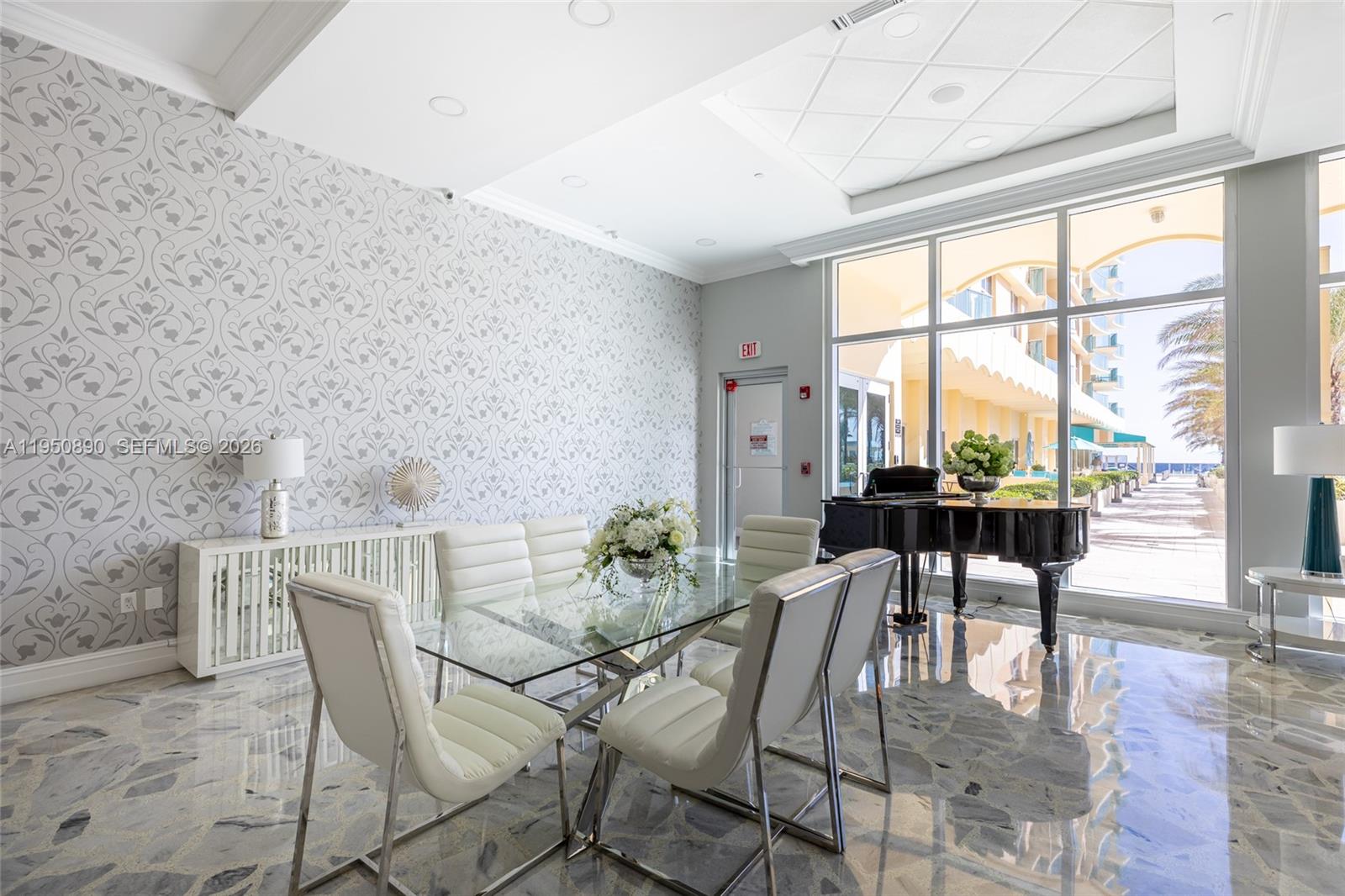 A dining area features a glass table, white chairs, patterned wallpaper, and a grand piano — 2501 S Ocean Dr # 439, Hollywood FL 33019, HOLLYWOOD, FL