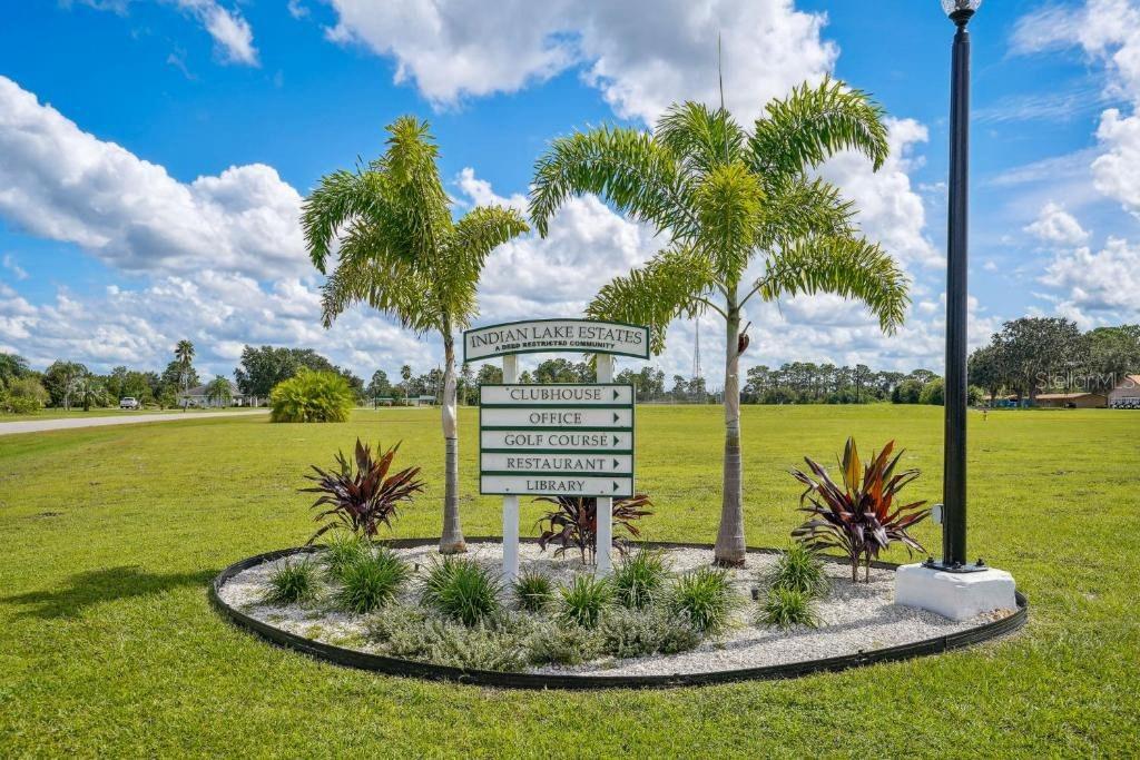 A sign for Indian Lake Estates stands in a grassy field between two palm trees — 107 JAPONICA AVENUE, INDIAN LAKE ESTATES, FL