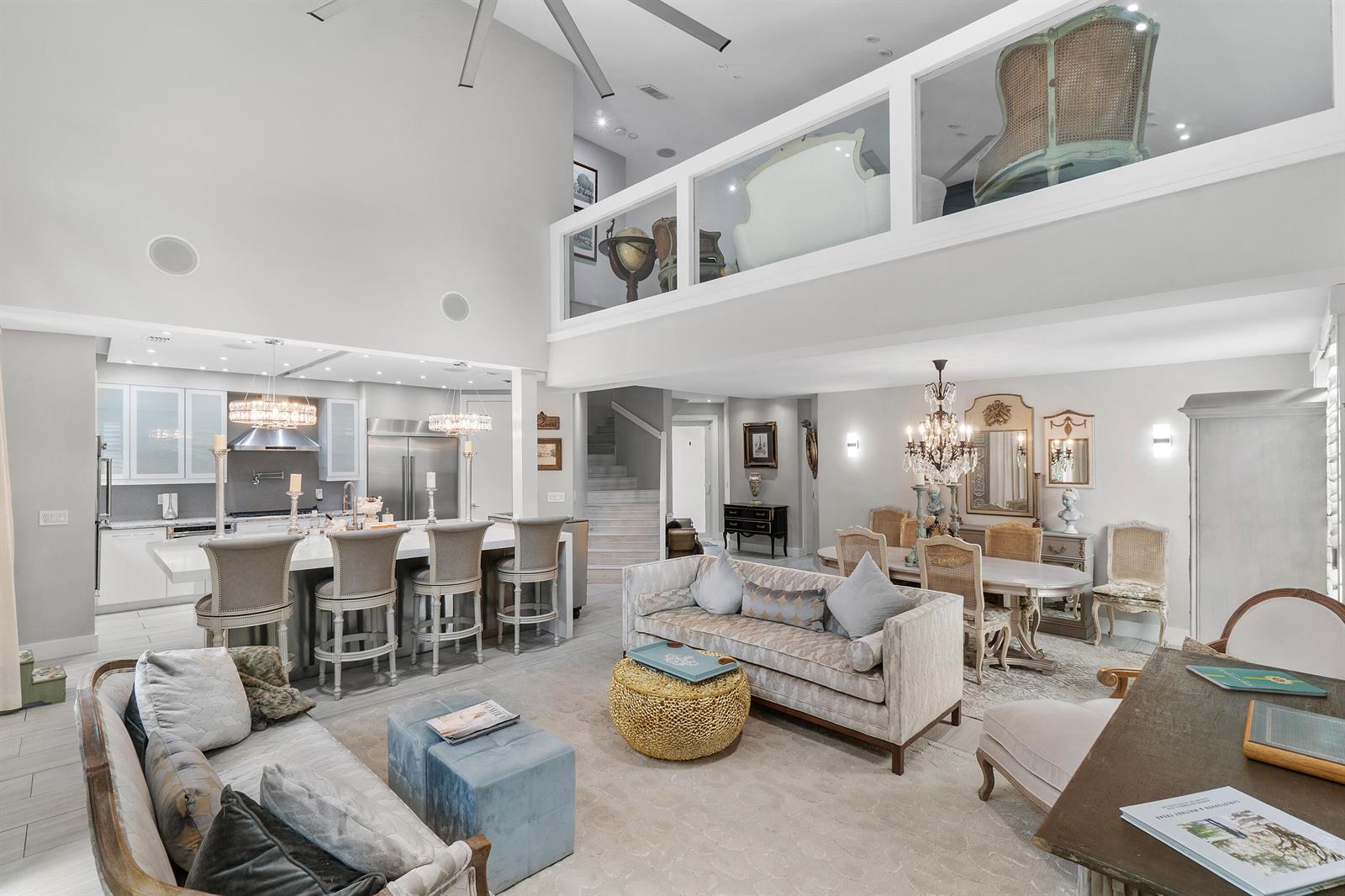 An open-concept living area features a kitchen, dining space, and a lofted mezzanine level — 2550 NW 52nd Street, Boca Raton FL 33496, BOCA RATON, FL