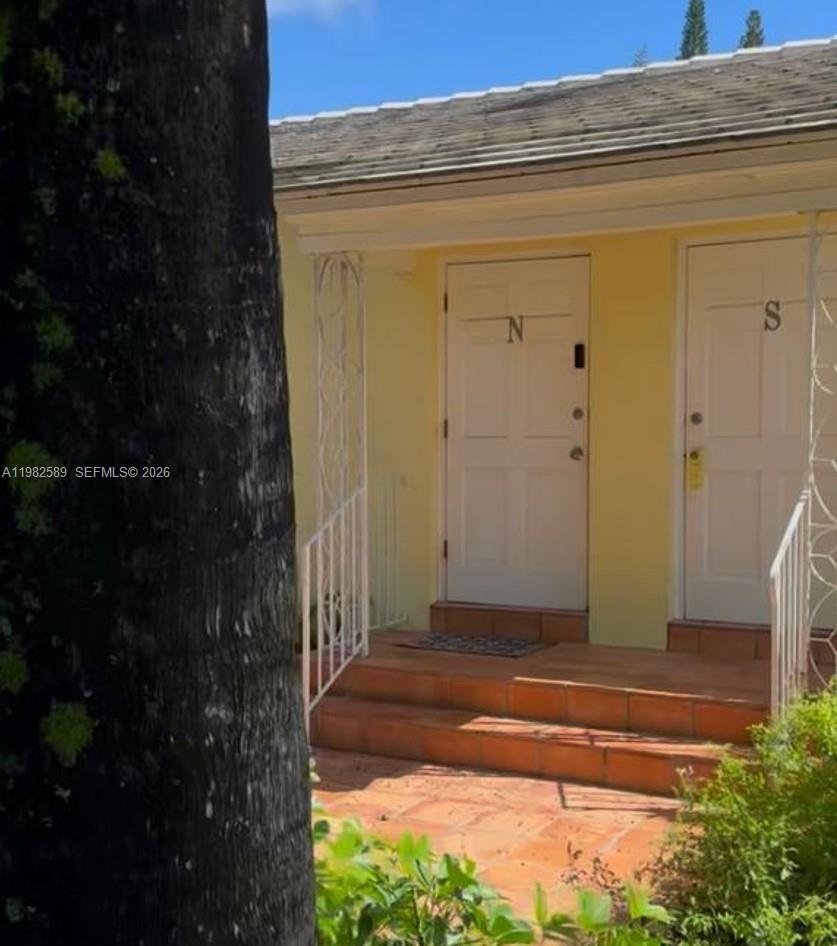 Two white doors labeled N and S are set in a yellow exterior wall — 1015 NE 112th St, Biscayne Park FL 33161, BISCAYNE PARK, FL