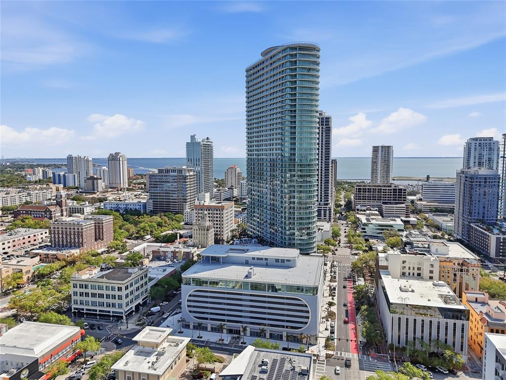 An aerial view of a city skyline featuring a prominent glass skyscraper and surrounding buildings — 400 CENTRAL AVENUE UNIT 303, ST PETERSBURG, FL