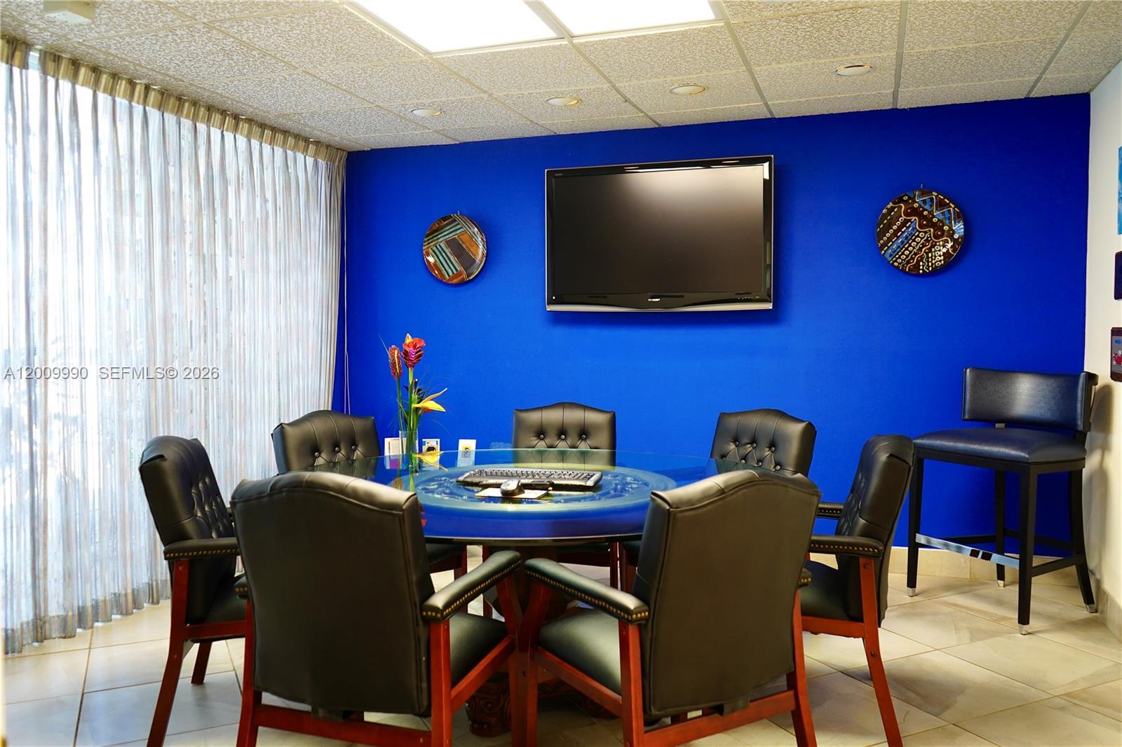 A conference room features a glass-topped table, black leather chairs, and a blue accent wall — 150 Westward Dr # 4, Miami Springs FL 33166, MIAMI SPRINGS, FL
