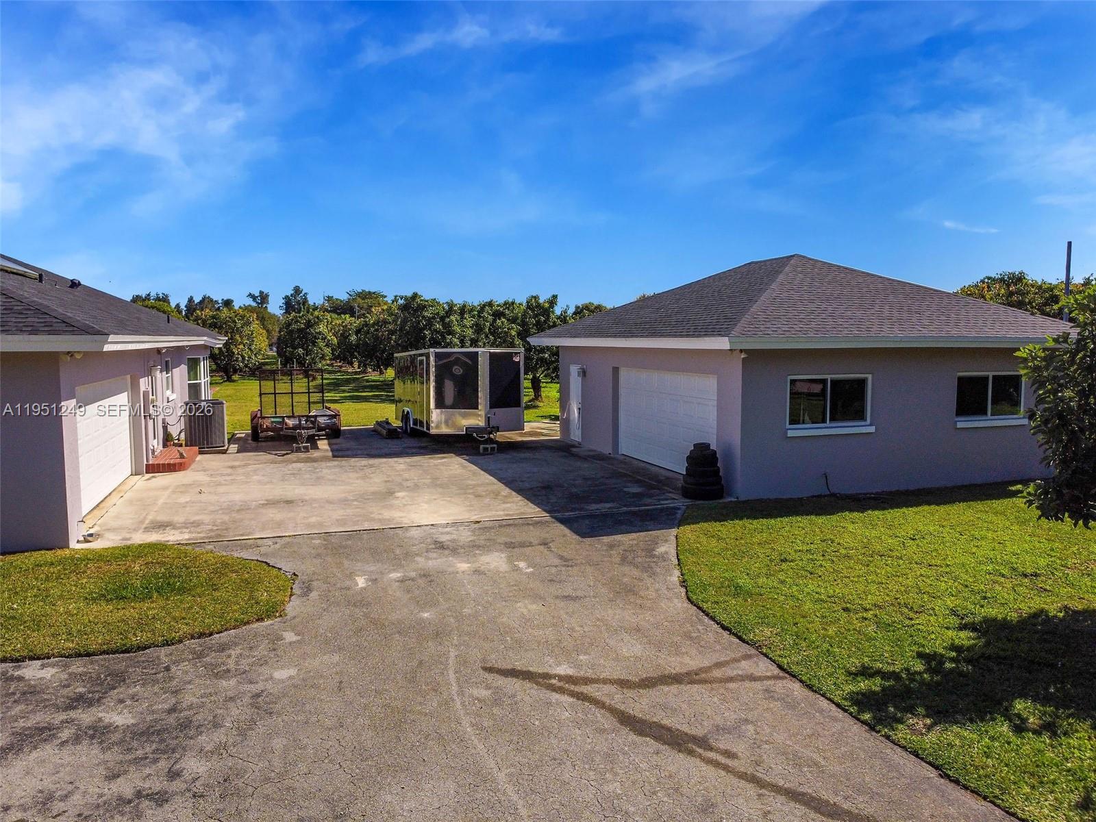 An aerial view shows two detached buildings with a concrete driveway and a trailer between them — 23505 SW 153rd Ave, Homestead FL 33032, HOMESTEAD, FL