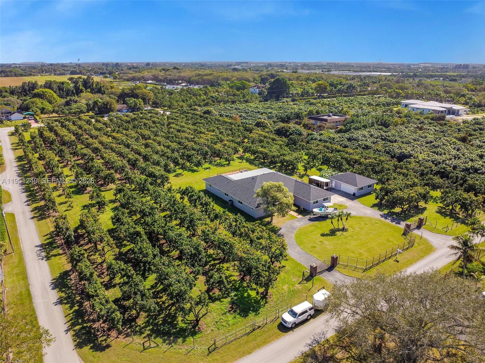 An aerial view shows a house with a large orchard and a circular driveway — 23505 SW 153rd Ave, Homestead FL 33032, HOMESTEAD, FL
