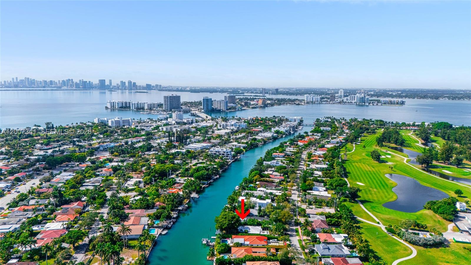 An aerial view shows a waterfront house with a red arrow pointing toward it — 550 S Shore Dr, Miami Beach FL 33141, MIAMI BEACH, FL