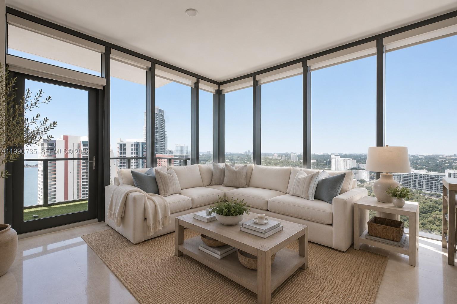 A living room features a white sectional sofa, a wooden coffee table, and floor-to-ceiling windows — 1451 Brickell Ave # 2704, Miami FL 33131, MIAMI, FL