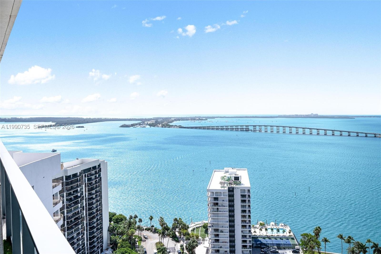 An elevated view of a bay with a long bridge and nearby high-rise buildings — 1451 Brickell Ave # 2704, Miami FL 33131, MIAMI, FL