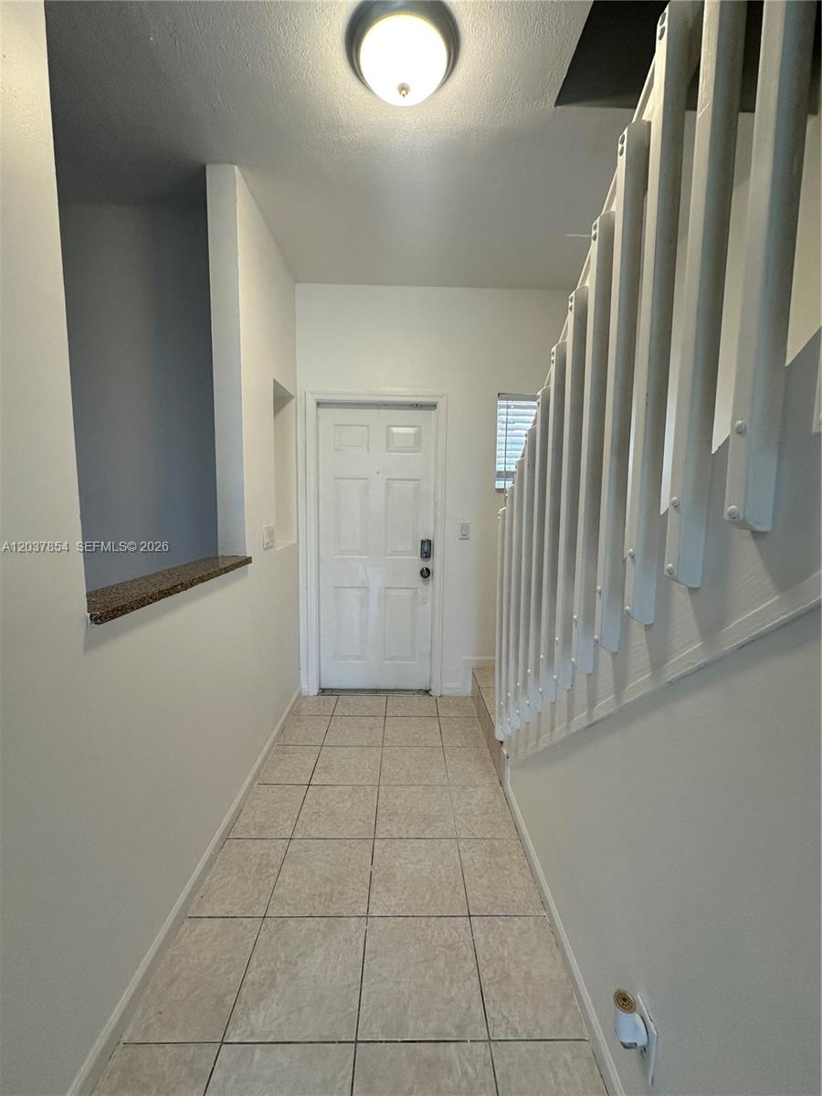An entryway features tiled flooring, a white front door, and a staircase with white railings — 5541 NW 90th Ter # 5541, Sunrise FL 33351, SUNRISE, FL