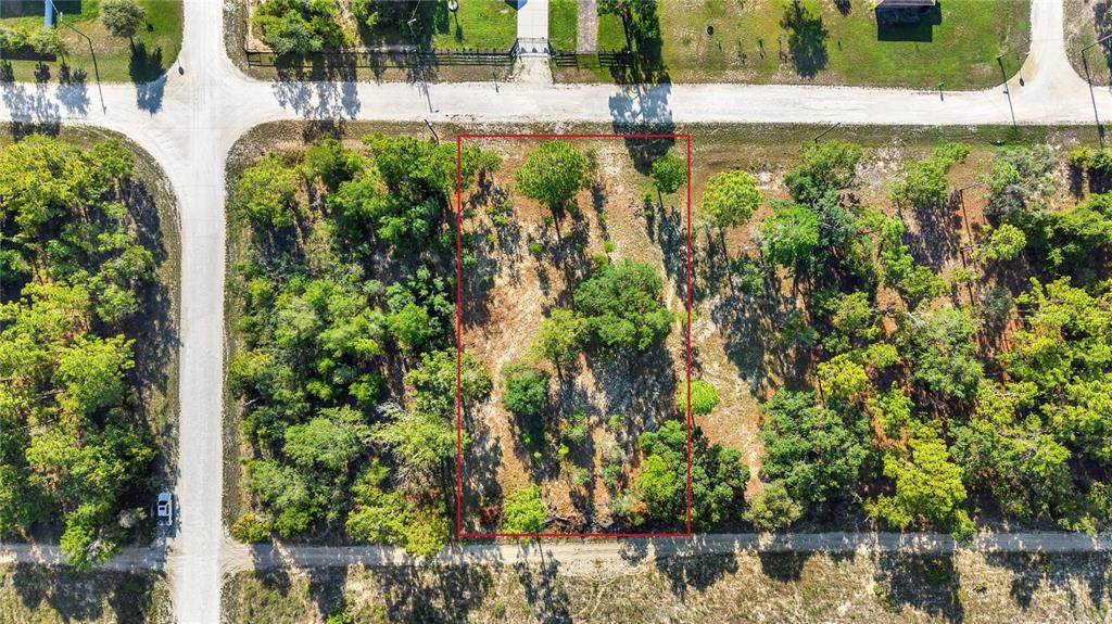 An aerial view shows a rectangular, tree-covered vacant lot outlined in red — 0 CONDOR ROAD, BROOKSVILLE, FL