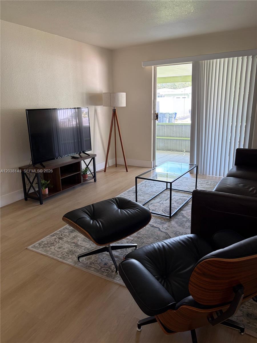 A dining area features a high-top table with metal stools in front of a window — 1635 Dewey St # B, Hollywood FL 33020, HOLLYWOOD, FL