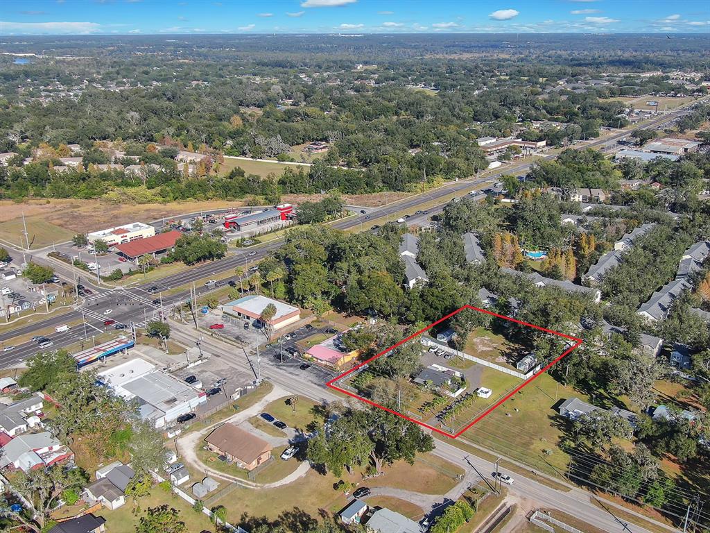 An aerial view shows a residential lot outlined in red near a commercial intersection — 105 S SAINT CLOUD AVENUE, VALRICO, FL