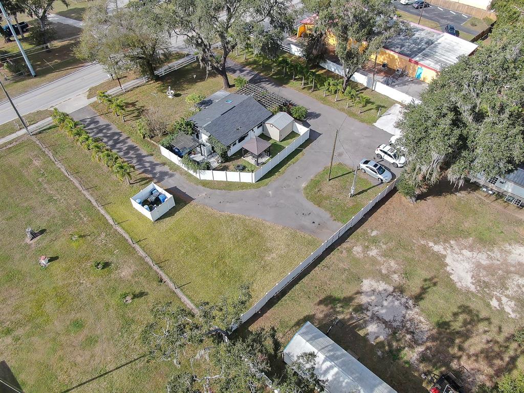 An aerial view shows a house with a fenced yard, driveway, and detached shed — 105 S SAINT CLOUD AVENUE, VALRICO, FL