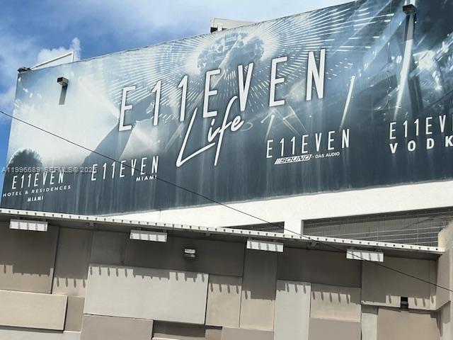 A large E11EVEN brand billboard is mounted on the exterior wall of a building — 20 NE 11 st # 3301, Miami FL 33132, MIAMI, FL