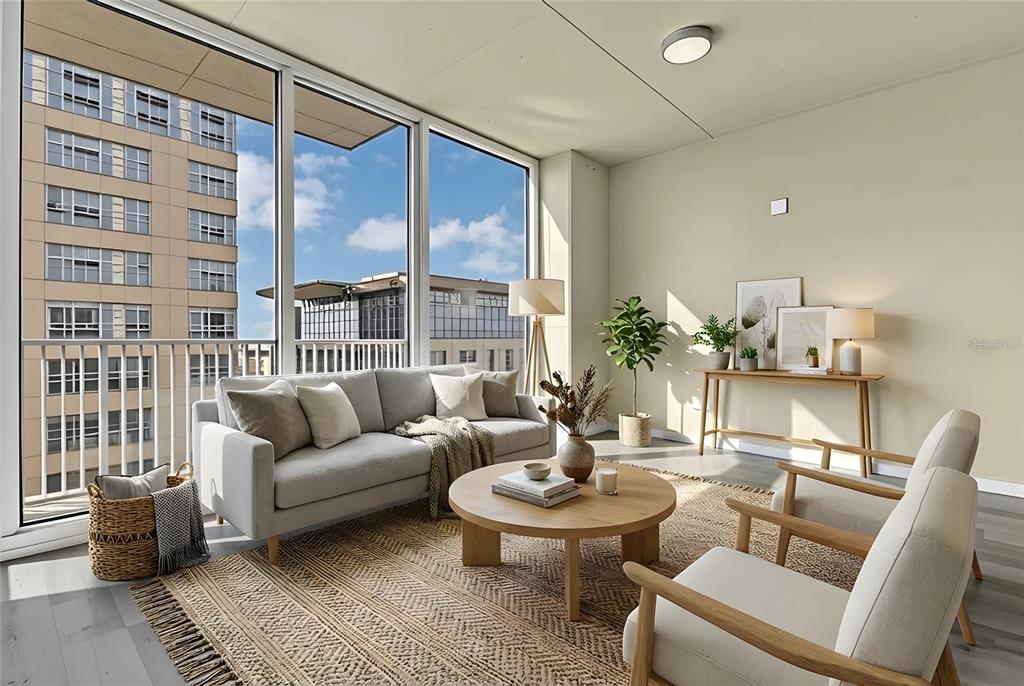 A bright living room features a grey sofa, wooden coffee table, and floor-to-ceiling windows — 155 S COURT AVENUE UNIT 1506, ORLANDO, FL