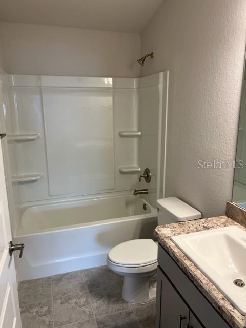 A bathroom features a white tub-shower combo, a toilet, and a vanity with a sink — 2206 NW 23RD LOOP, OCALA, FL
