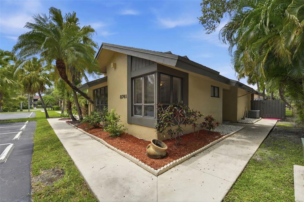 A tan, single-story house with a brown trim and a palm-lined front yard — 8741 CLEARY BOULEVARD, FORT LAUDERDALE, FL