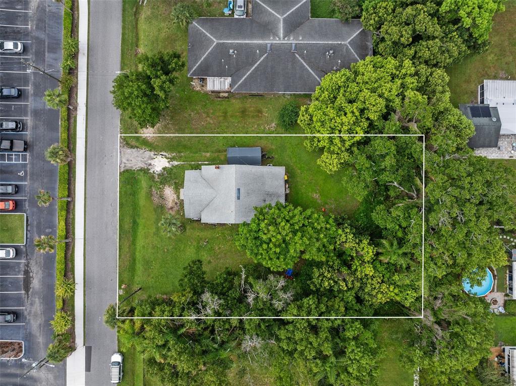 A single-story house with beige siding, a red front door, and red brick corner accents — 918 SHOREVIEW DRIVE, ORLANDO, FL