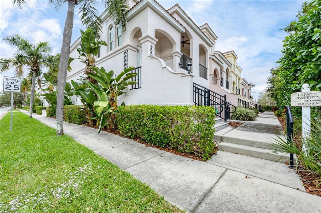 A multi-story residential building with a beige stucco exterior and a manicured hedge — 455 NOKOMIS AVENUE S UNIT 455, VENICE, FL