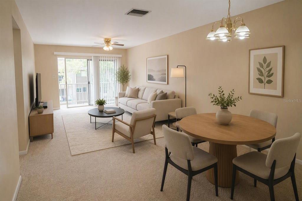 An open-concept living and dining area features neutral walls, carpeted floors, and a sliding door — 4610 W GRAY STREET UNIT 307, TAMPA, FL