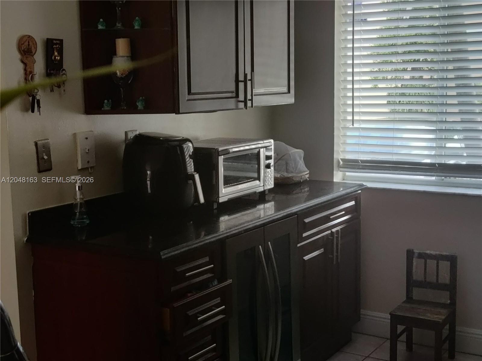 A kitchen counter features dark cabinets, a toaster oven, an air fryer, and a window — 14063 SW 177th St, Miami FL 33177, MIAMI, FL
