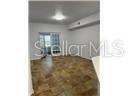 An empty room with wood-look flooring, white walls, and a sliding glass door — 827 CAMARGO WAY UNIT 307, ALTAMONTE SPRINGS, FL