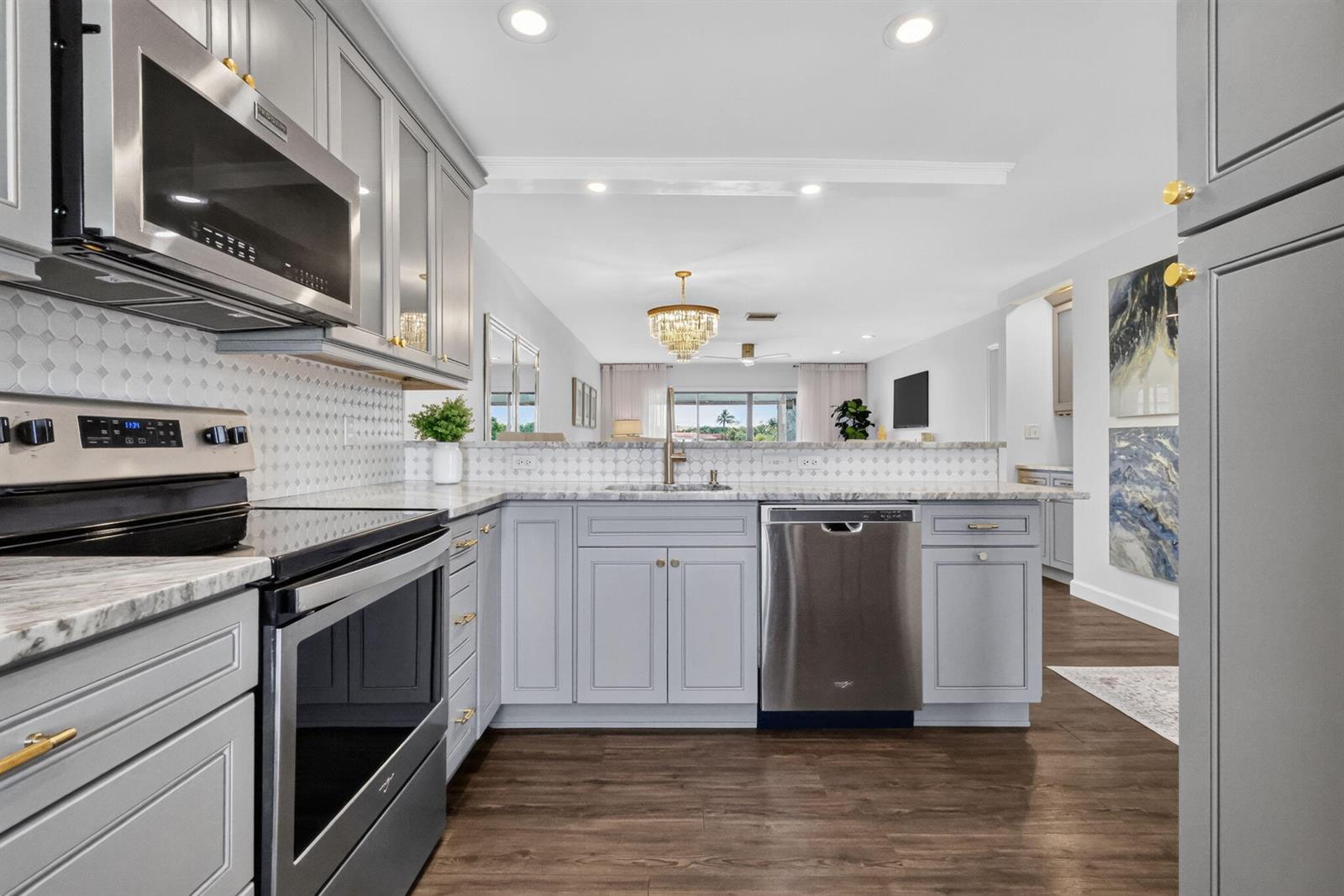 A kitchen features light gray cabinets, stainless steel appliances, and a marble-patterned countertop — 21219 Lago Circle # 5j, Boca Raton FL 33433, BOCA RATON, FL