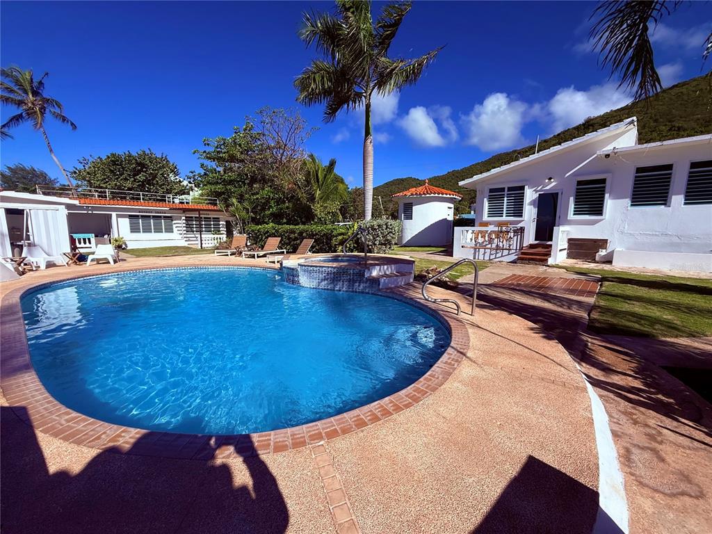 A swimming pool with a hot tub sits in the backyard of a white house — Carr #3 BEACH FRONT GUEST HOUSE, PATILLAS, PR