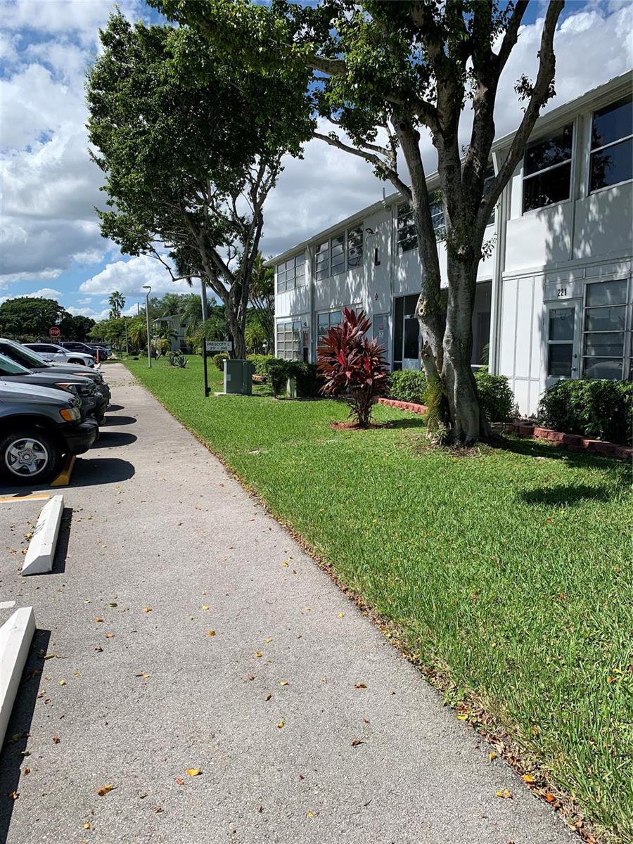 A two-story white apartment building sits beside a parking lot and a grassy lawn — 236 Prescott-l # 236, Deerfield Beach FL 33442, DEERFIELD BEACH, FL