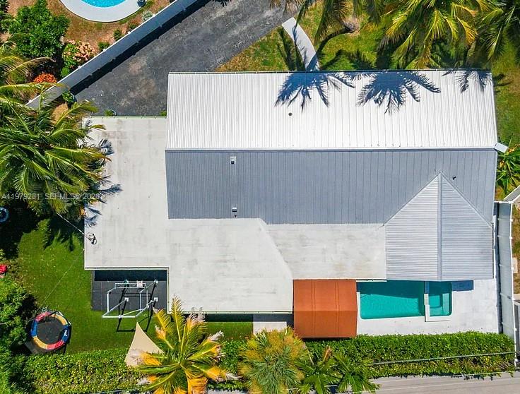 An aerial view shows a house with a metal roof, a pool, and a backyard — 2211 NE 35th Ct, Lighthouse Point FL 33064, LIGHTHOUSE POINT, FL